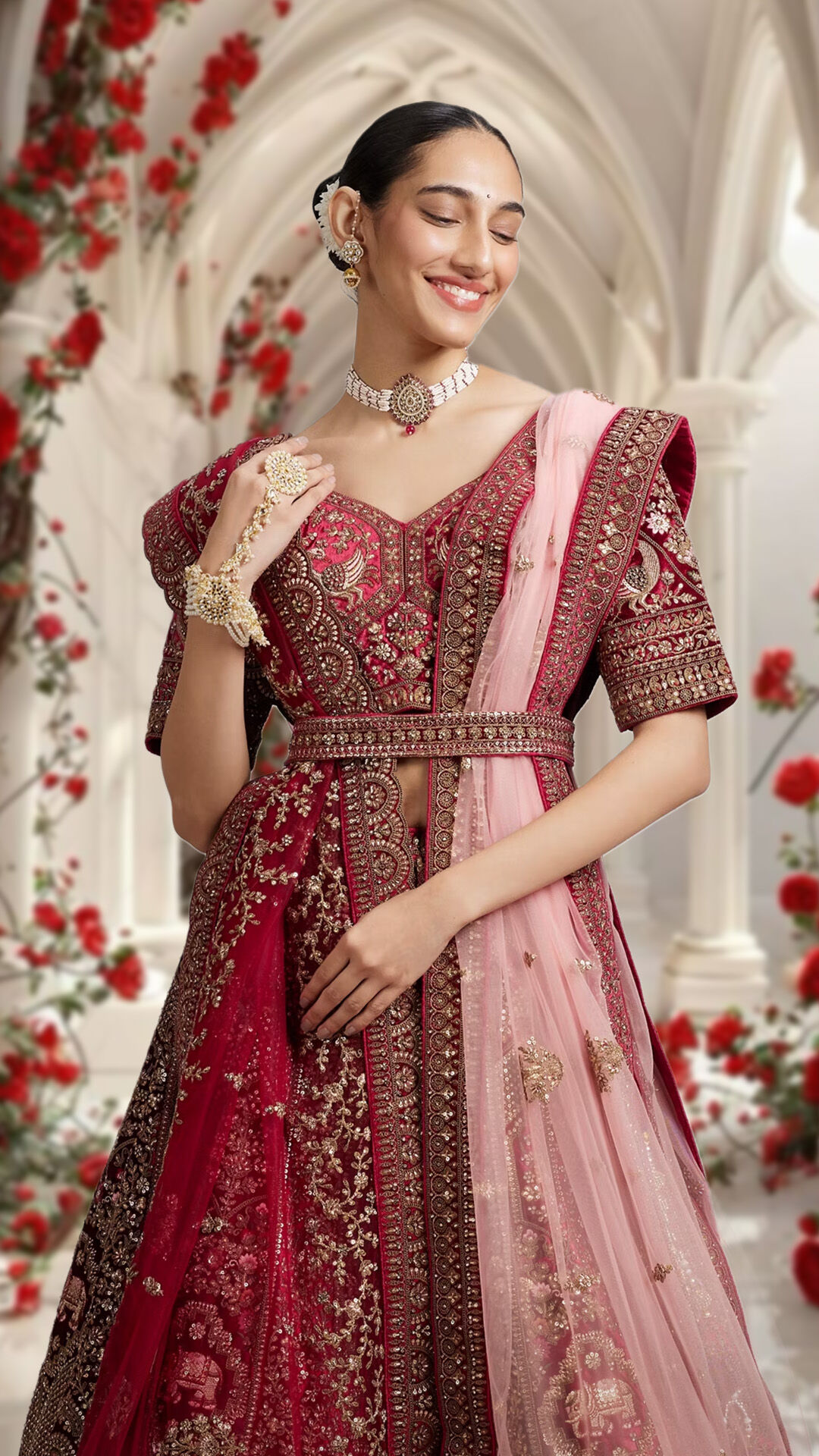 Bride or wedding guest showcasing a red lehenga beautifully styled with a pink dupatta for a striking ensemble.